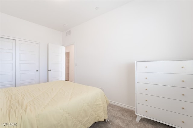 carpeted bedroom with a closet, visible vents, and baseboards