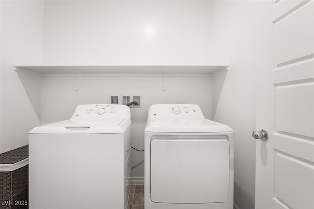 clothes washing area featuring laundry area and washer and clothes dryer