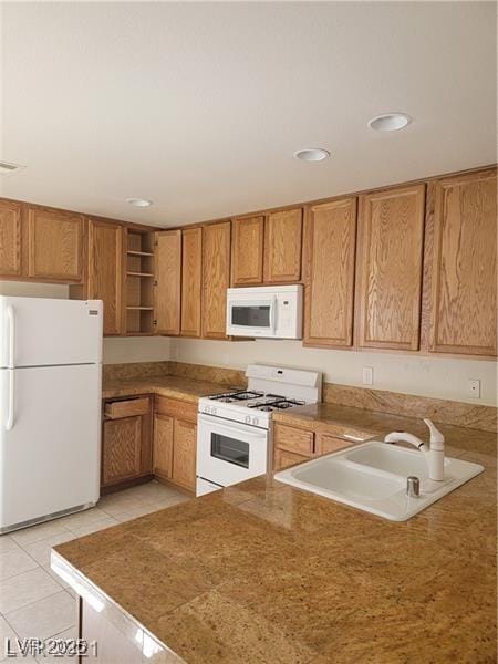 kitchen with white appliances, brown cabinetry, open shelves, a sink, and light tile patterned flooring