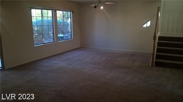 empty room with stairs, carpet, and baseboards