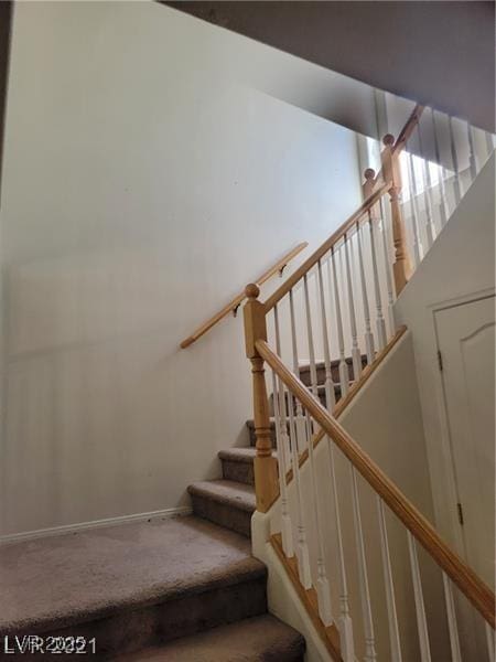 stairs featuring carpet and baseboards