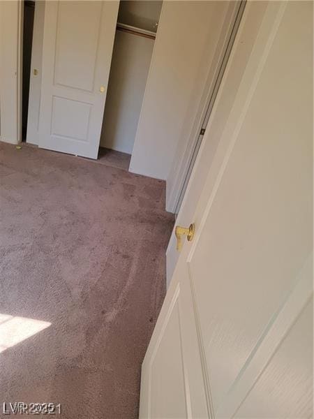 unfurnished bedroom with a closet and carpet flooring