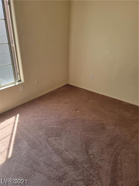 carpeted spare room with baseboards