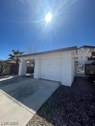 garage with concrete driveway