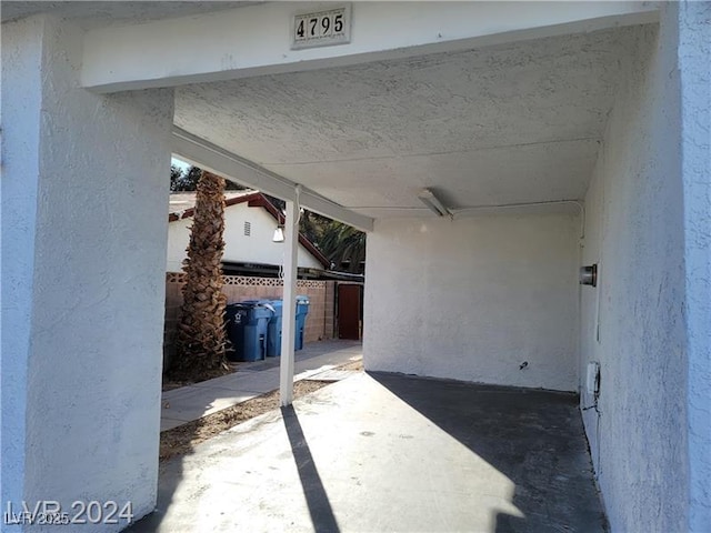 view of patio / terrace with fence and a carport