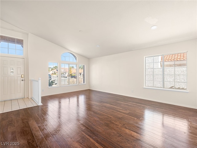 interior space with plenty of natural light, baseboards, and hardwood / wood-style floors