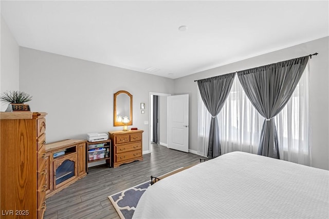 bedroom with baseboards and wood finished floors