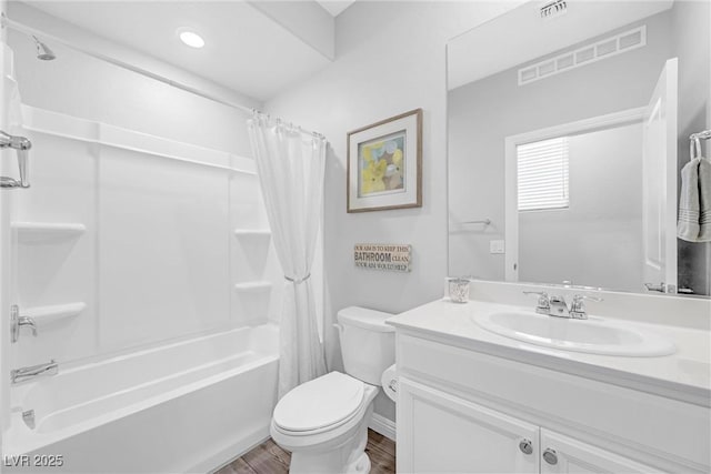 full bathroom featuring visible vents, vanity, toilet, and shower / bath combo with shower curtain