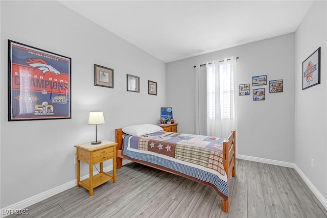 bedroom featuring light wood-style flooring and baseboards