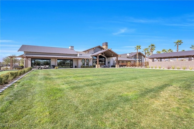 rear view of property with a yard