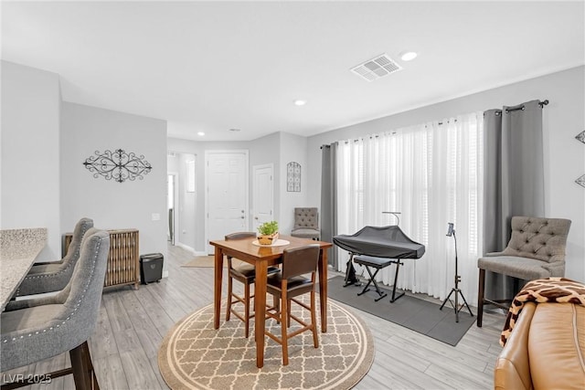 dining room with light wood-style flooring, visible vents, and recessed lighting