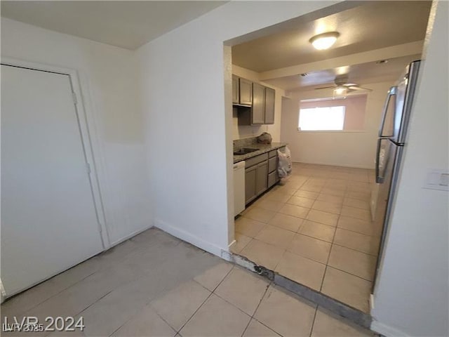 kitchen featuring light tile patterned floors, light countertops, freestanding refrigerator, ceiling fan, and dishwasher