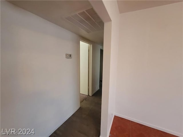 hallway with visible vents and baseboards