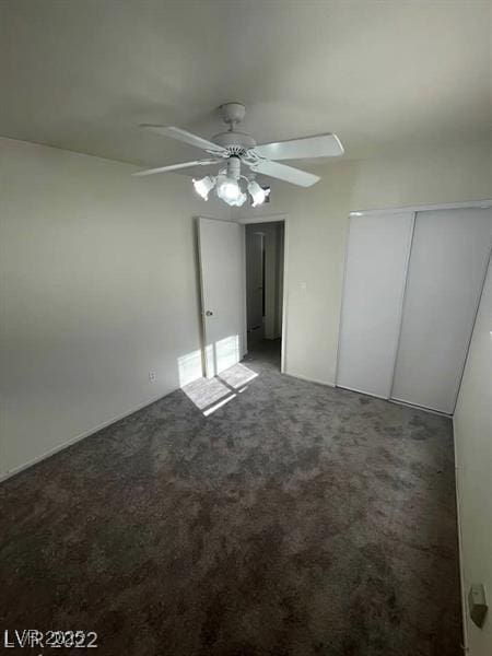 unfurnished bedroom featuring a closet, carpet flooring, and ceiling fan