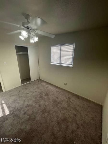 unfurnished bedroom featuring ceiling fan, a closet, and carpet