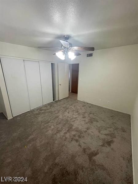 unfurnished bedroom featuring light carpet, ceiling fan, a closet, and visible vents