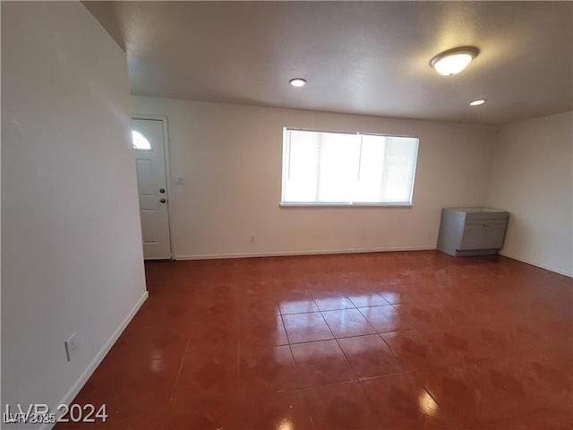 spare room with baseboards, recessed lighting, and tile patterned floors