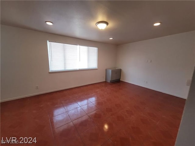 tiled spare room with baseboards and recessed lighting