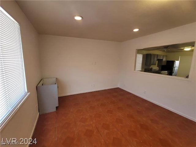 unfurnished room with recessed lighting and baseboards