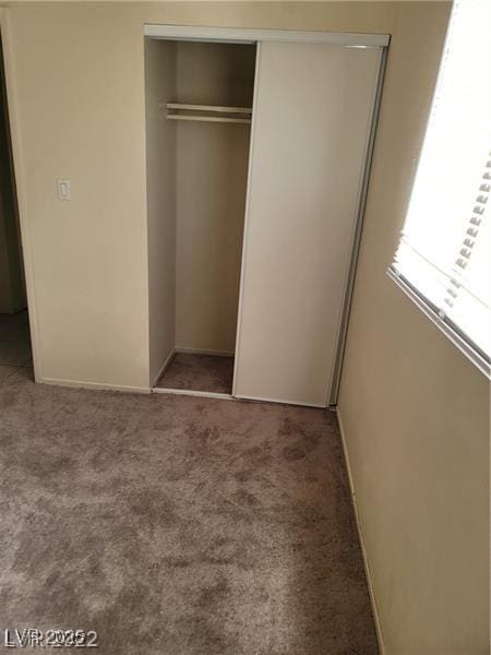 unfurnished bedroom featuring a closet and carpet