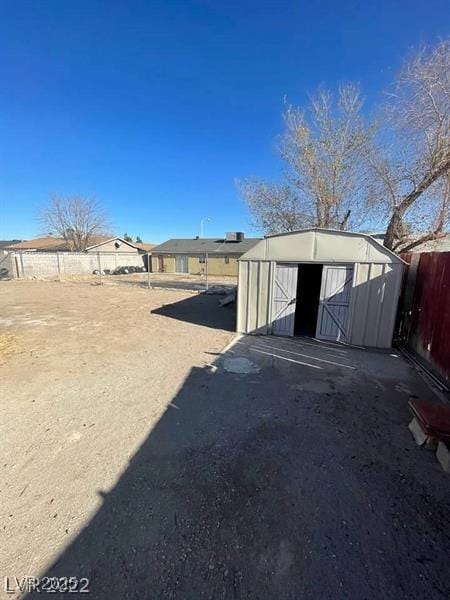 view of shed featuring fence