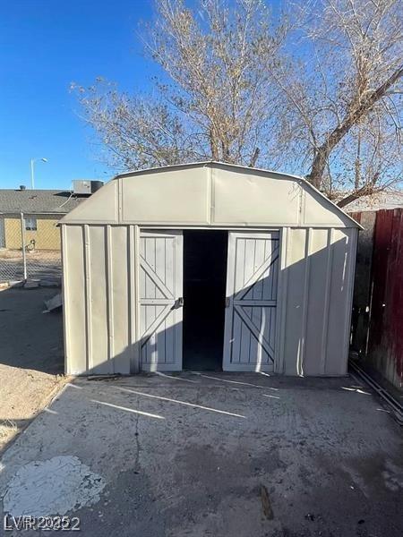 view of shed with fence