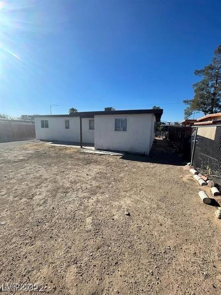 back of property featuring a fenced backyard and stucco siding