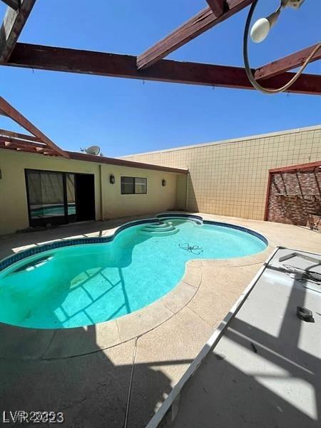 view of swimming pool with a fenced in pool and a patio area