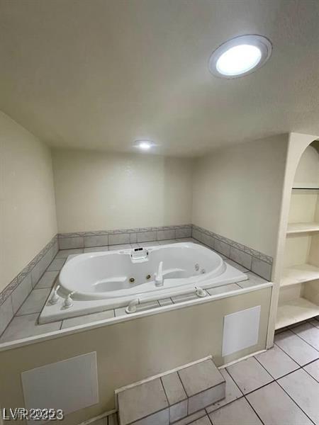 bathroom featuring a whirlpool tub and tile patterned floors