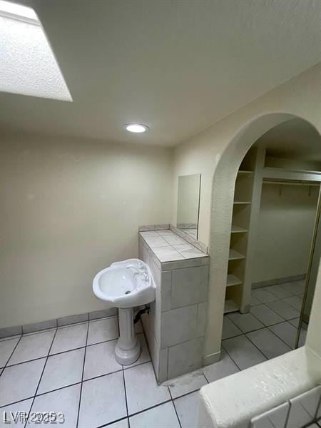 bathroom with built in features and tile patterned floors