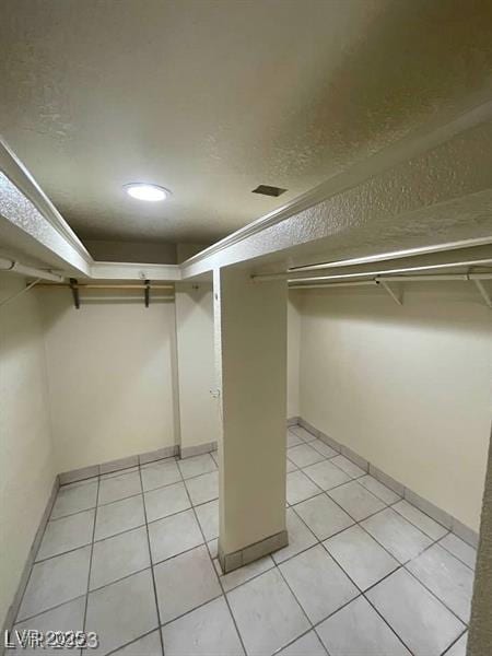 spacious closet featuring light tile patterned floors