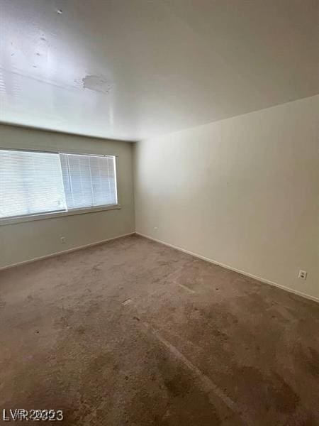 carpeted empty room featuring plenty of natural light