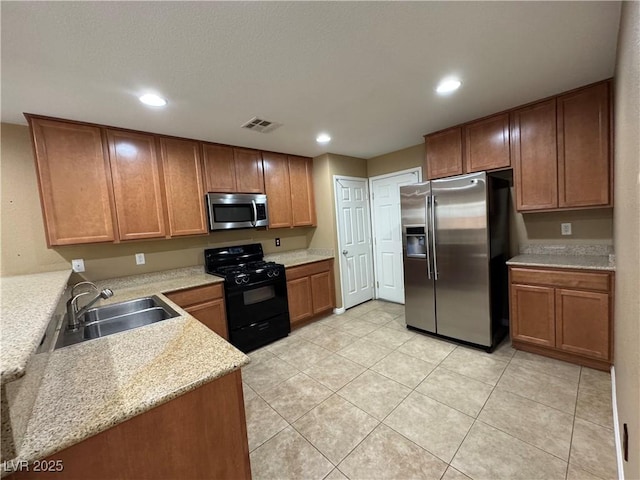 kitchen with light tile patterned floors, visible vents, appliances with stainless steel finishes, a sink, and recessed lighting