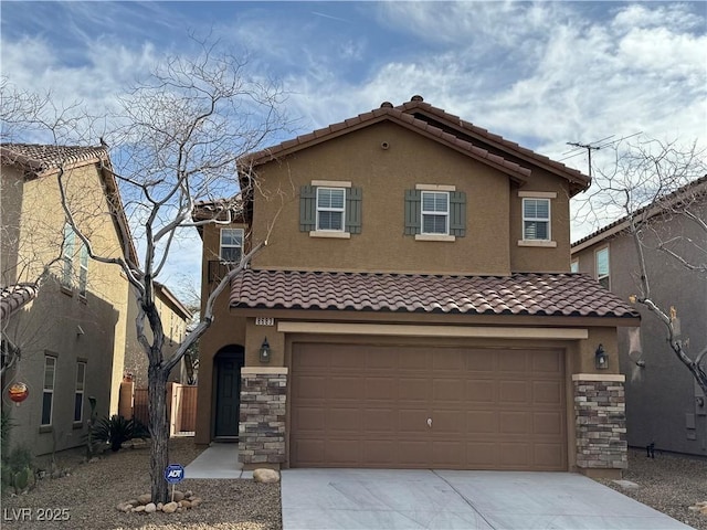 mediterranean / spanish house featuring a garage, stone siding, concrete driveway, and stucco siding