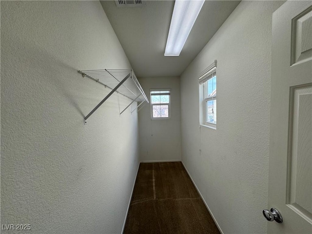 spacious closet featuring visible vents