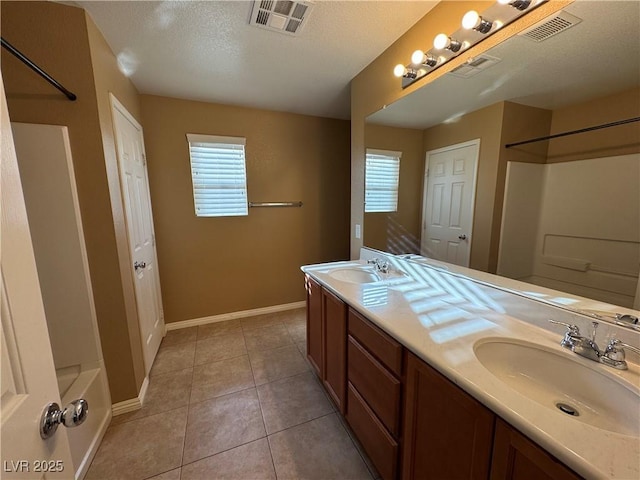 bathroom featuring a sink, visible vents, and tile patterned floors