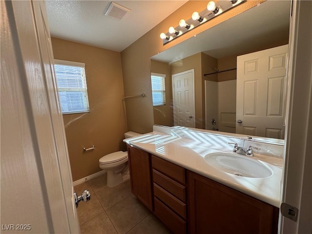 bathroom with a shower, visible vents, toilet, vanity, and tile patterned flooring