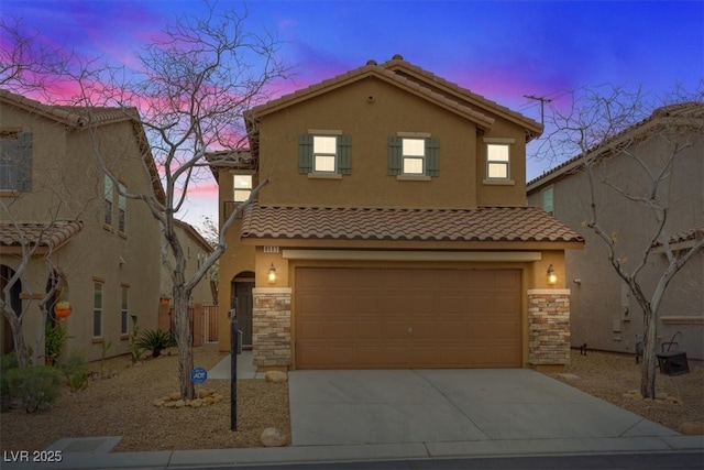 view of front of home with an attached garage, a tile roof, stucco siding, stone siding, and driveway