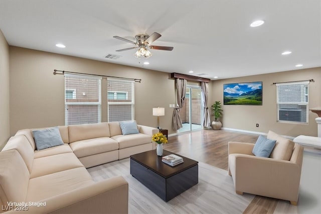 living room featuring light wood finished floors, visible vents, baseboards, recessed lighting, and a ceiling fan