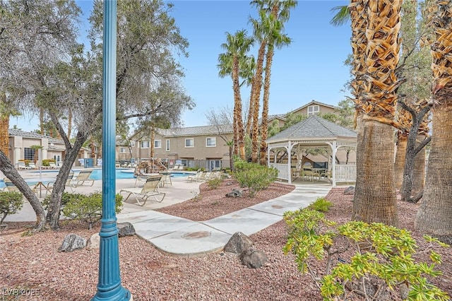 view of home's community with a gazebo, a pool, and a patio