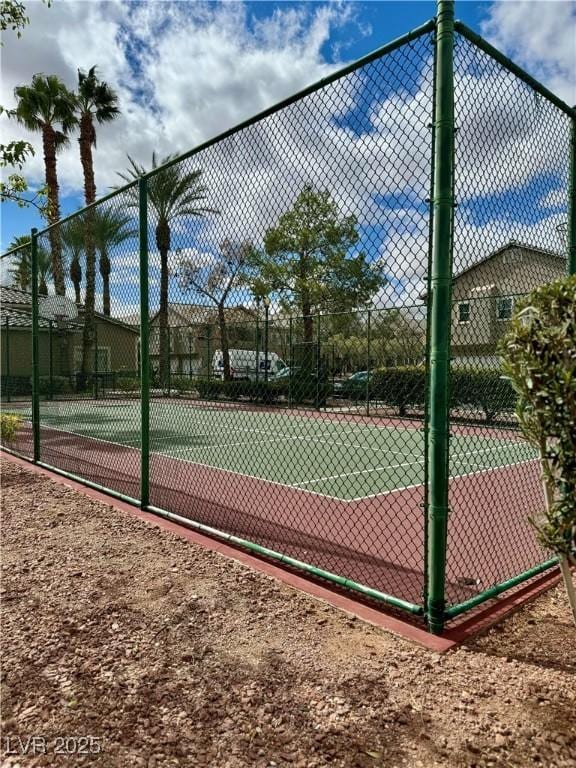 view of basketball court featuring fence