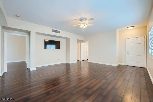 unfurnished living room with visible vents, baseboards, dark wood-type flooring, and a ceiling fan