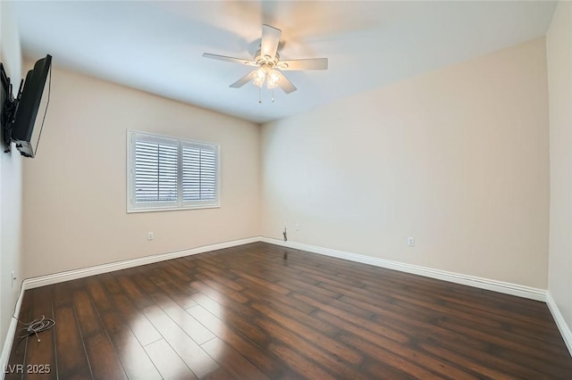 unfurnished room with baseboards, dark wood-type flooring, and ceiling fan