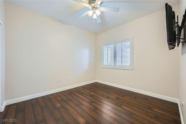 spare room featuring a ceiling fan, wood finished floors, and baseboards