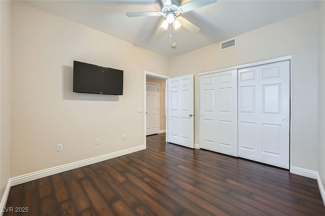 unfurnished bedroom with visible vents, baseboards, dark wood finished floors, a closet, and a ceiling fan