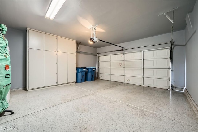 garage featuring baseboards and a garage door opener