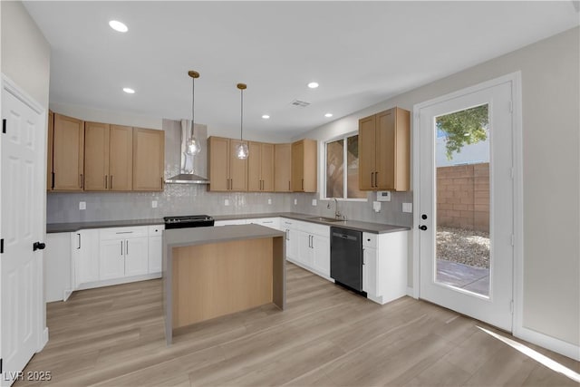 kitchen with black dishwasher, tasteful backsplash, stove, wall chimney range hood, and a sink