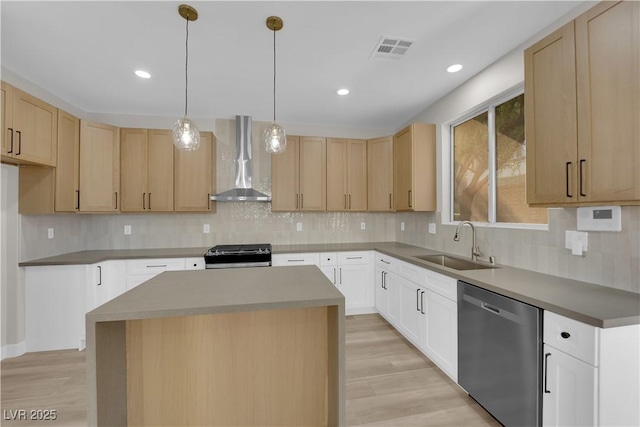 kitchen with light wood-style flooring, a sink, visible vents, appliances with stainless steel finishes, and wall chimney range hood