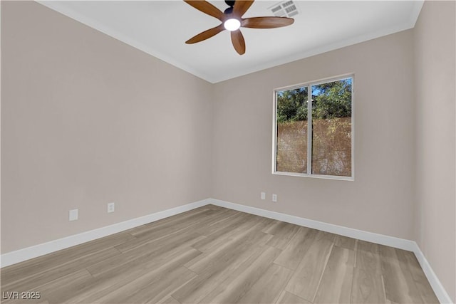 unfurnished room featuring crown molding, visible vents, a ceiling fan, light wood-type flooring, and baseboards