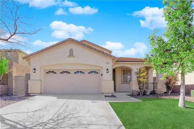 mediterranean / spanish house featuring a garage, concrete driveway, a front lawn, and stucco siding